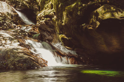 Scenic view of river flowing through rocks