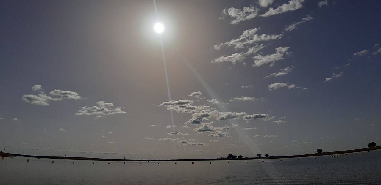 sky, water, horizon, nature, moon, astronomical object, cloud, beauty in nature, scenics - nature, tranquility, sea, moonlight, reflection, light, no people, outdoors, sunlight, sun, tranquil scene, dusk, beach, silhouette, evening