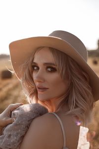 Portrait of young woman wearing hat
