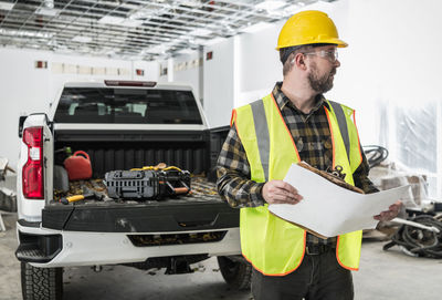 Auto mechanic inspecting car at garage