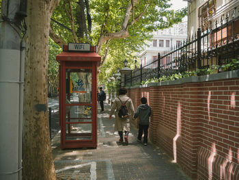 Shanghai rear view of people walking on footpath in city