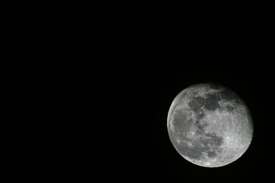 Low angle view of moon against clear sky at night