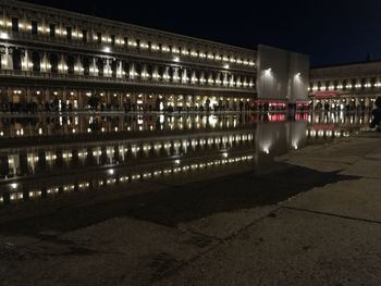 Illuminated building against sky at night