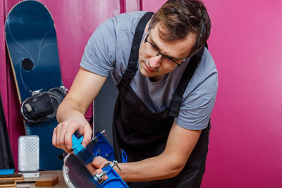 Young man working at workshop