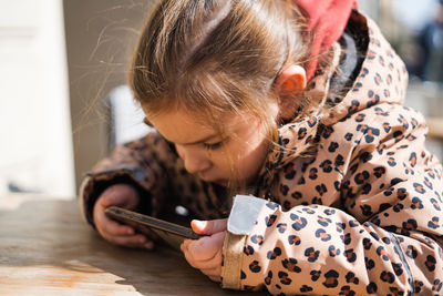 Close-up of girl using mobile phone