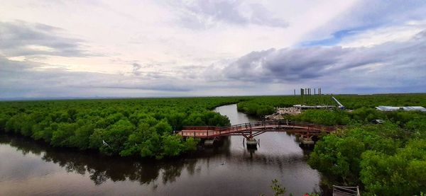 Arch bridge over river against sky