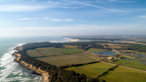 Aerial view of landscape and sea against sky