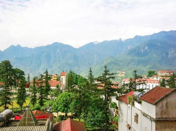 High angle view of townscape and mountains against sky