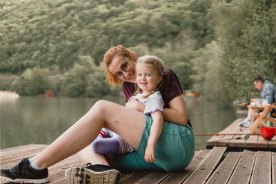 Girl with mom on a lake