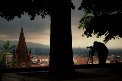 Silhouette man working against sky