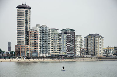 Paddleboarder and city skyline