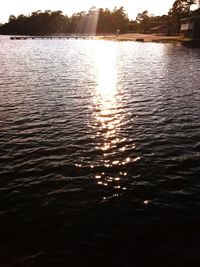 Scenic view of lake against sky at sunset