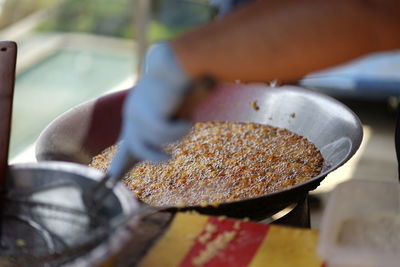 Close-up of hand cooking 