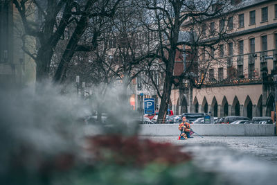 People on street amidst buildings in city