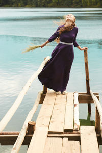 Woman standing on pier at lake