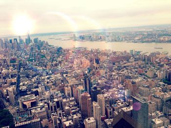 Aerial view of city against cloudy sky