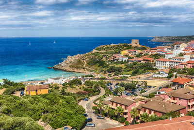 High angle view of townscape by sea against sky