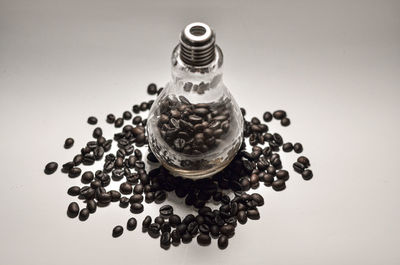 High angle view of bottles on table against white background