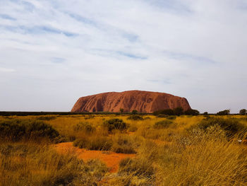 Scenic view of rocks on field against sky