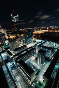 High angle view of illuminated buildings in city at night