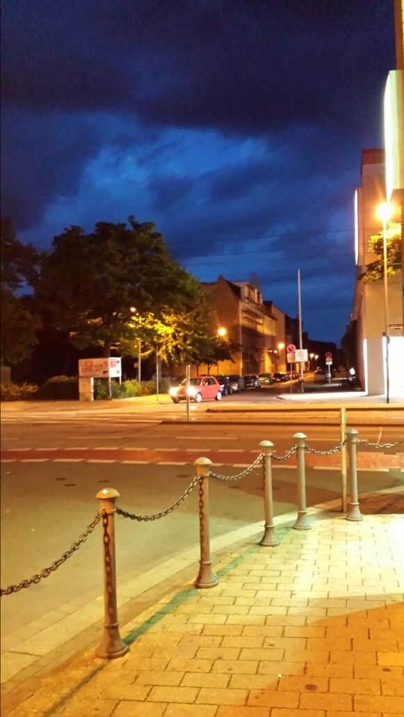 illuminated, architecture, built structure, building exterior, sky, night, street light, cloud - sky, lighting equipment, city, dusk, the way forward, tree, street, outdoors, railing, no people, light - natural phenomenon, house, residential building