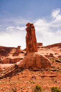 Rock formations against cloudy sky