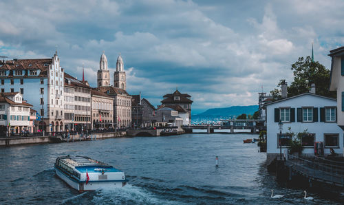 Boat in canal along built structures