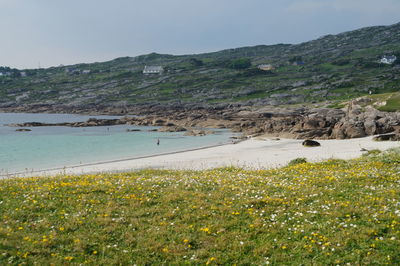 Scenic view of sea and mountains against sky