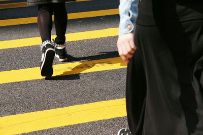 Low section of man standing on road