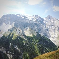 Scenic view of mountains against cloudy sky