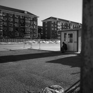 Man on street against buildings in city