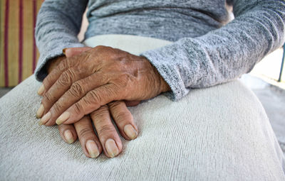 Midsection of woman with hands clasped