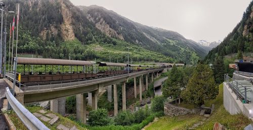 Bridge amidst mountains against clear sky