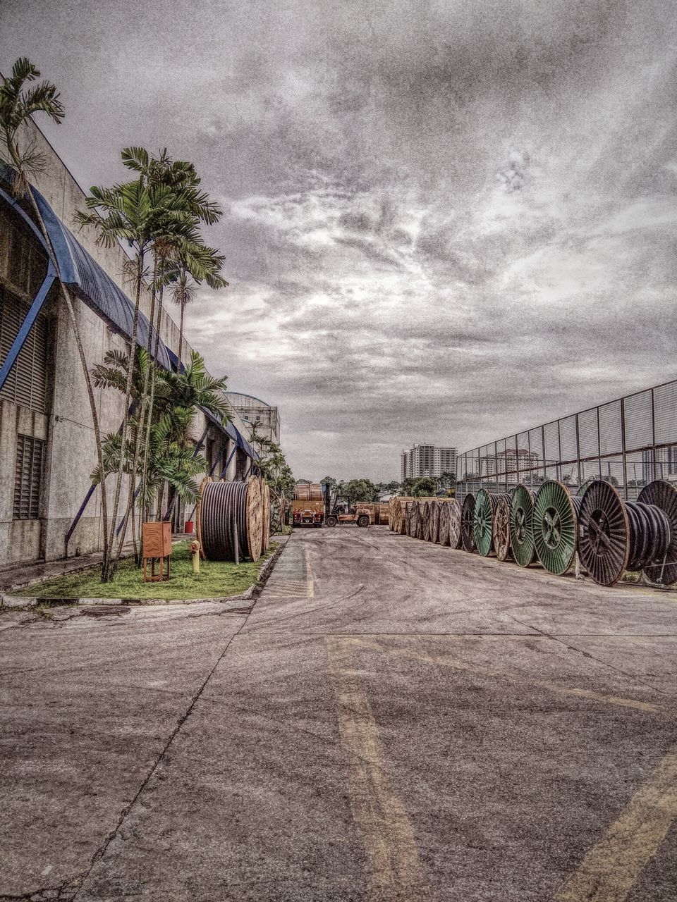 STREET BY BUILDINGS AGAINST SKY