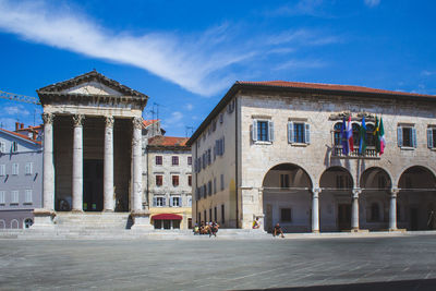 Buildings in town against sky