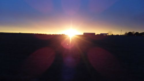 Silhouette landscape against sky during sunset