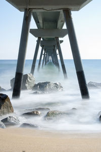 Scenic view of pier over sea against sky