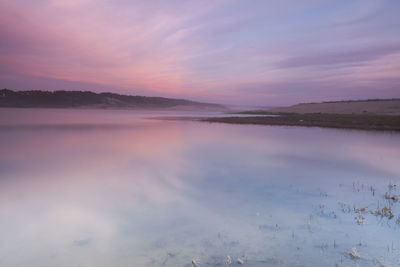 Scenic view of lake against sky during sunset