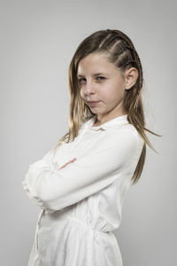 Portrait of teenage girl standing against white background