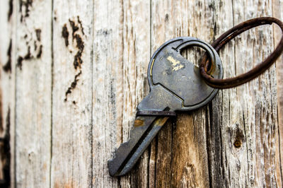 Close-up of rusty key on wooden table