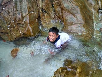 Portrait of smiling young man in water