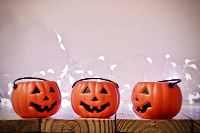 View of pumpkins against orange wall