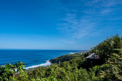 Scenic view of sea against blue sky