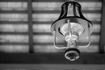 Low angle view of light bulb hanging from ceiling