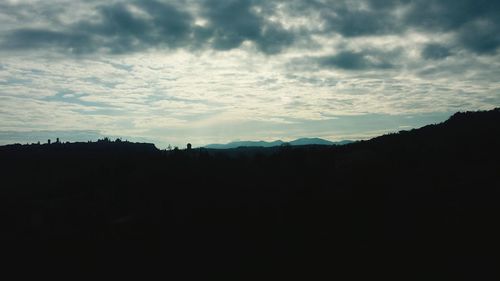 Silhouette landscape against sky during sunset