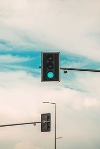 Low angle view of road sign against sky