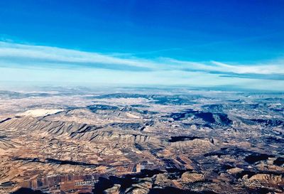 Aerial view of landscape against blue sky