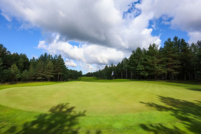 Panoramic view of golf course against sky