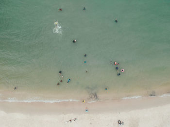 Aerial view of people enjoying in sea