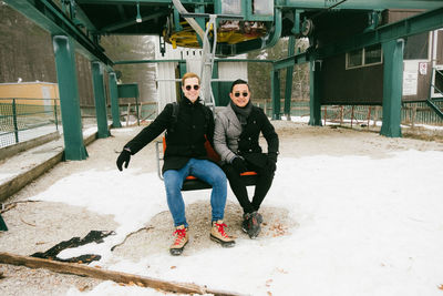 Full length of people on ski lift